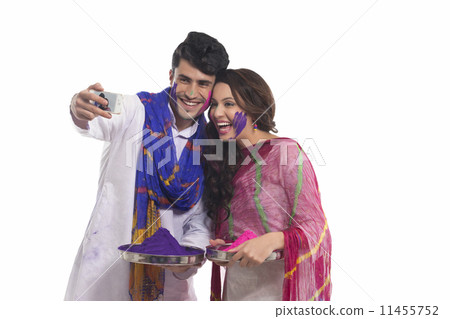 Couple with holi colours taking a self portrait Couple with holi colours taking a self portrait 11455752