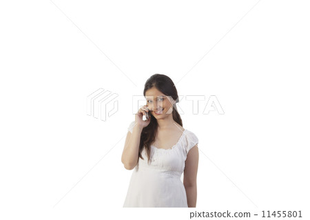Pregnant woman talking on the mobile phone 11455801