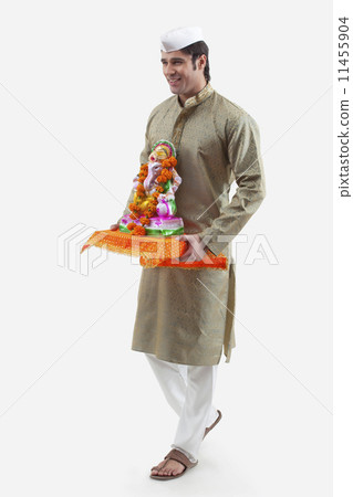 Maharashtrian man holding a Ganesh idol Maharashtrian man holding a Ganesh idol 11455904