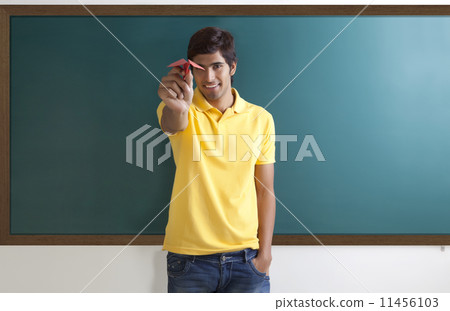 Portrait of a college student with a paper aeroplane 11456103