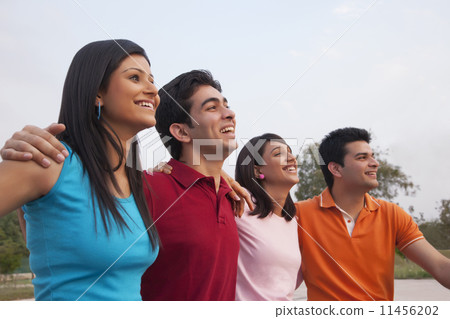Cheerful friends looking away outdoors 11456202