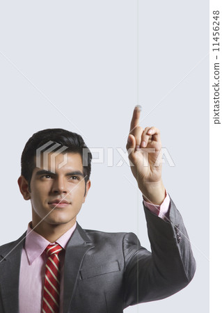 Young businessman touching visual screen against white background 11456248