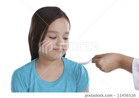 Little girl having medicine 11456526