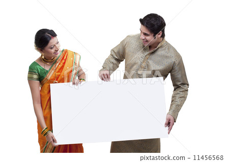 Maharashtrian couple holding a placard Maharashtrian couple holding a placard 11456568
