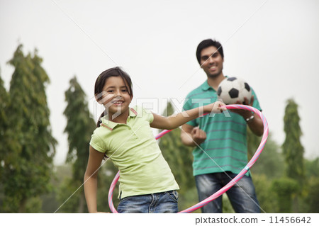 Portrait of a girl with her father playing outdoors 11456642