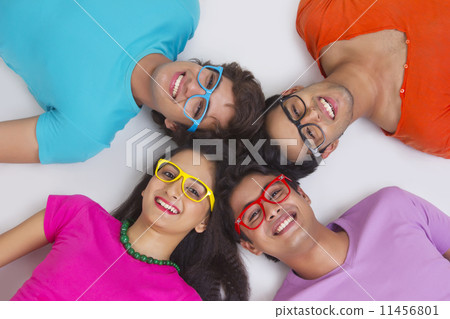 Directly above shot of friends lying with their heads together on white background 11456801