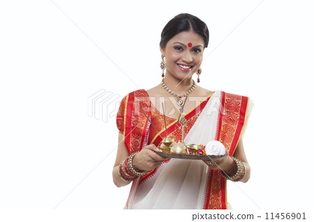 Portrait of a Bengali woman holding a puja thali 11456901