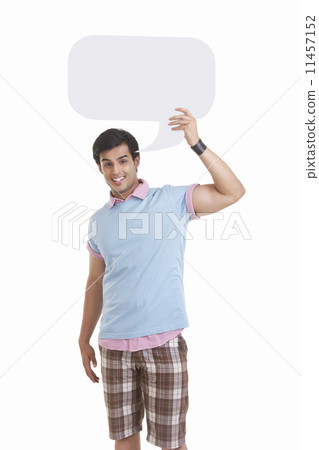 Portrait of happy young man holding speech bubble over white background Portrait of happy young man holding speech bubble over white background 11457152