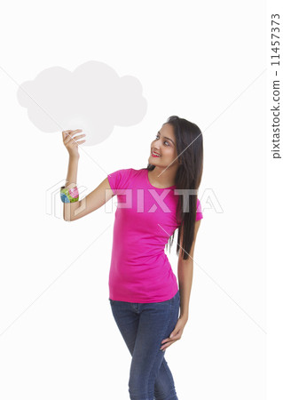 Happy young woman holding thought bubble over white background 11457373