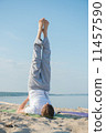 Man practices yoga 11457590
