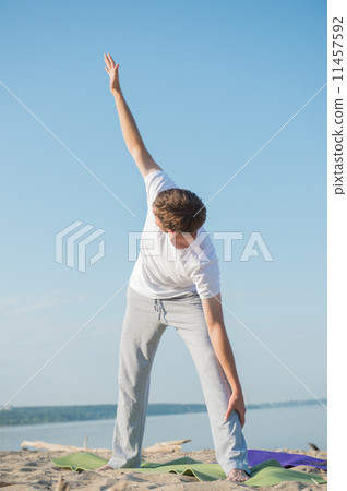 Man practices yoga Man practices yoga 11457592