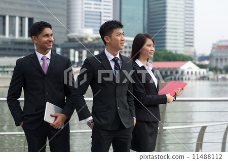 Three successful young asian colleagues of difference ethnicity looking towards the future 11488112