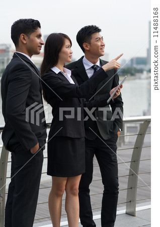 Three young, dynamic of multi-ethnicity real estate colleagues looking towards a pointed diection Three young, dynamic of multi-ethnicity real estate colleagues looking towards a pointed diection 11488168