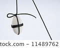 White stone suspended by rope against a white background. 11489762