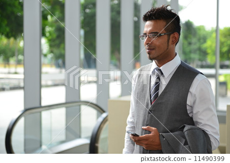 Businessman in city escalator 11490399