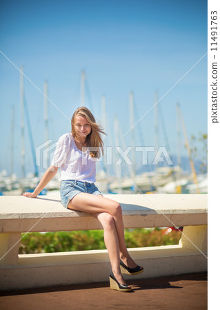 Young girl enjoying her vacation by the sea 11491763