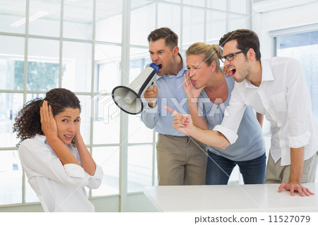 Casual business team shouting at a colleague 11527079
