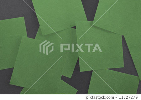 Green paper strewn over black 11527279