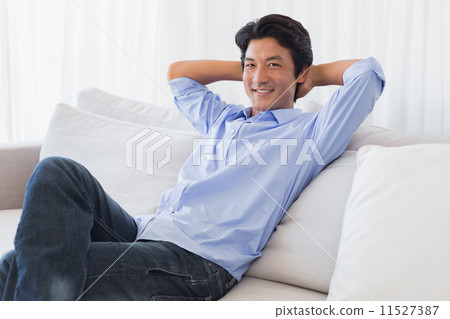 Happy man relaxing on couch 11527387
