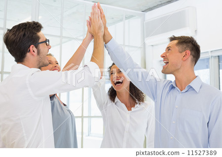 Casual business team high fiving 11527389