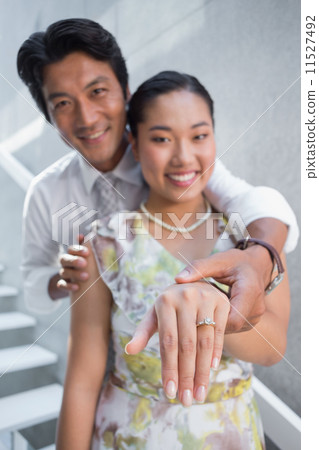 Couple showing engagement ring on womans finger 11527492