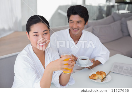 Couple in bathrobes spending the morning together Couple in bathrobes spending the morning together 11527666