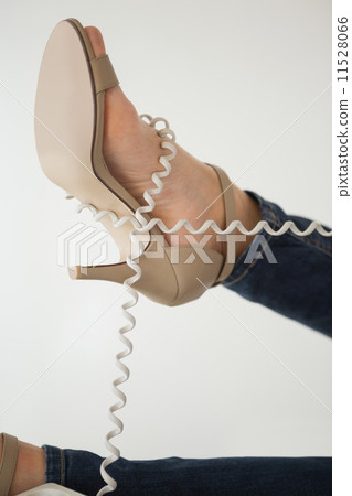 Phone cord wrapped around womans foot 11528066
