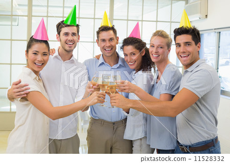 Casual smiling business team toasting with champagne 11528332