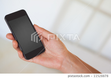 Womans hand holding black smartphone Womans hand holding black smartphone 11528878