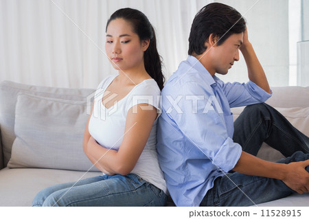 Couple not talking after a dispute on the sofa