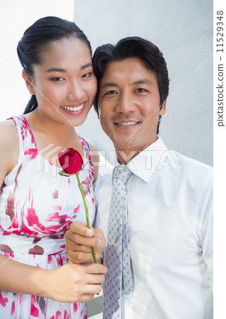 Man offering a red rose to girlfriend Man offering a red rose to girlfriend 11529348