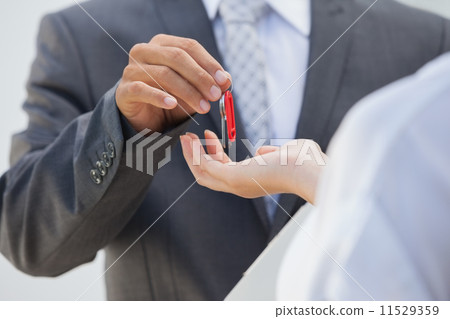 Estate agent giving the key to buyer Estate agent giving the key to buyer 11529359