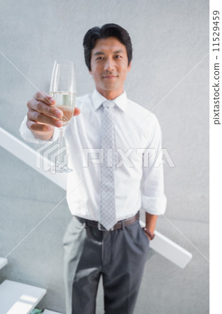 Happy man holding flute of champagne 11529459