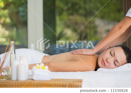 Relaxed brunette getting a back massage Relaxed brunette getting a back massage 11530826