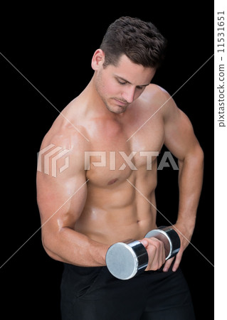 Focused crossfitter lifting up heavy dumbbell 11531651