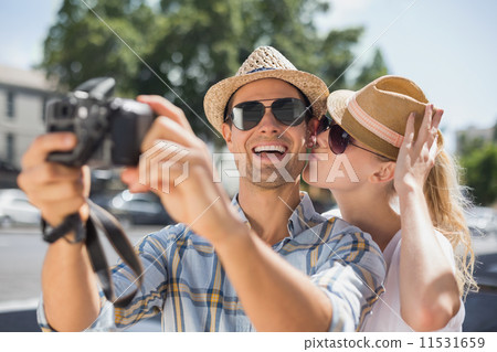 Hip young couple taking a selfie with camera 11531659