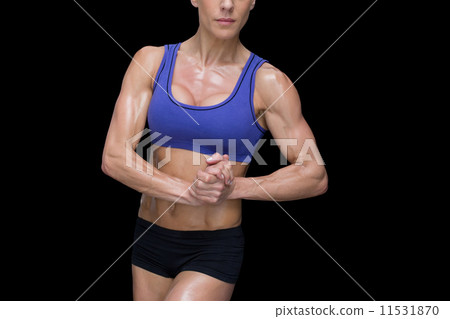 Strong woman posing in sports bra and shorts 11531870