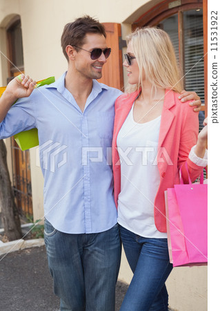Stylish young couple standing with shopping bags 11531922