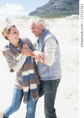 Attractive couple messing about on the beach Attractive couple messing about on the beach 11532382