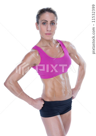 Female bodybuilder posing with hands on hips mid section 11532399