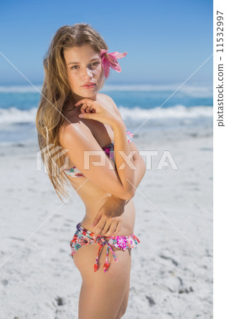 Beautiful blonde with flower hair accessory on the beach 11532997