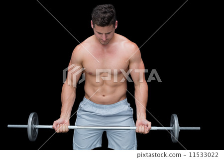 Serious crossfitter lifting up barbell Serious crossfitter lifting up barbell 11533022