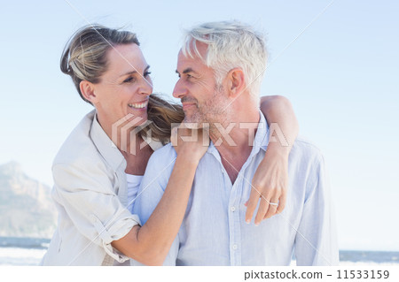 Attractive married couple hugging at the beach 11533159
