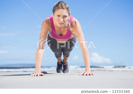 Fit blonde in plank position on the beach 11533160