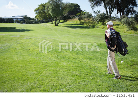 Golf player carrying his bag and walking Golf player carrying his bag and walking 11533451