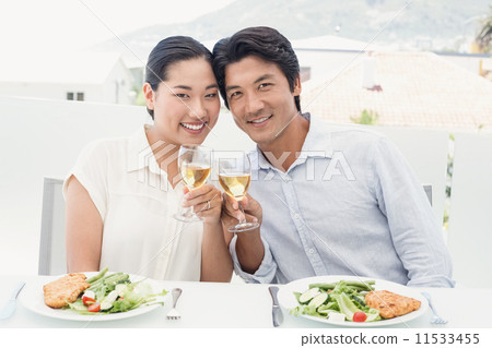 Happy asian couple having meal together 11533455