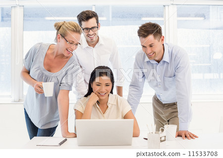 Casual business team having a meeting using laptop