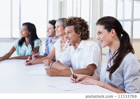 Casual business team taking notes in meeting Casual business team taking notes in meeting 11533769