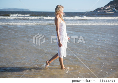Woman in white dress walking in the sea Woman in white dress walking in the sea 11533854