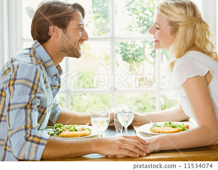 Happy couple enjoying a meal together Happy couple enjoying a meal together 11534074